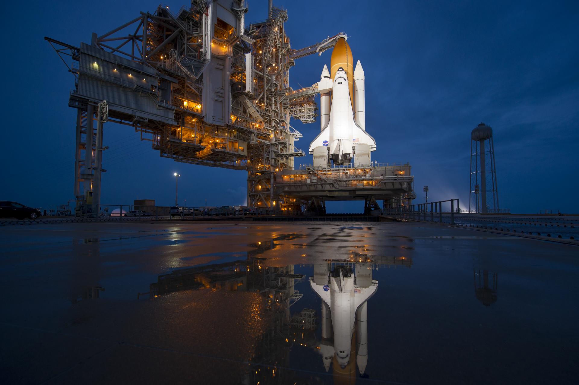 Photograph of a the space shuttle Atlantis before takeoff. NASA is an acronym that stands for National Aeronautics and Space Administration.
